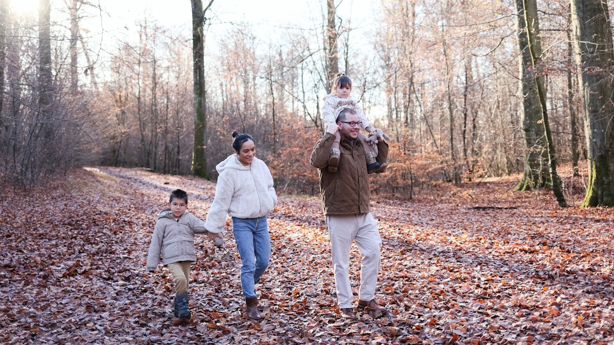 Family walking on a path in a forest